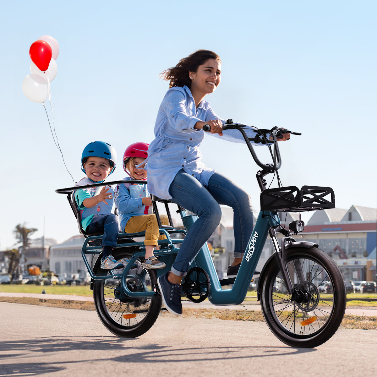 A girl riding a Onesport long-tail cargo e-bike on the sunnuy road, and the back rear are two children sitting on the e-bike child seat. And there are one red and three white balloons tied to the rear frame.